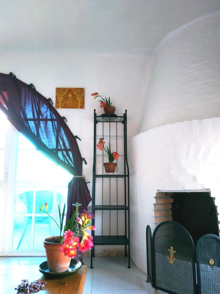 Hanitación Mil y una Noches chimenea ventana y flores