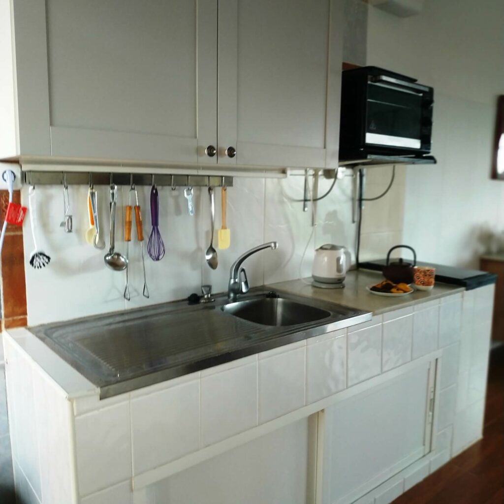 Kitchen area with utensils above a sink